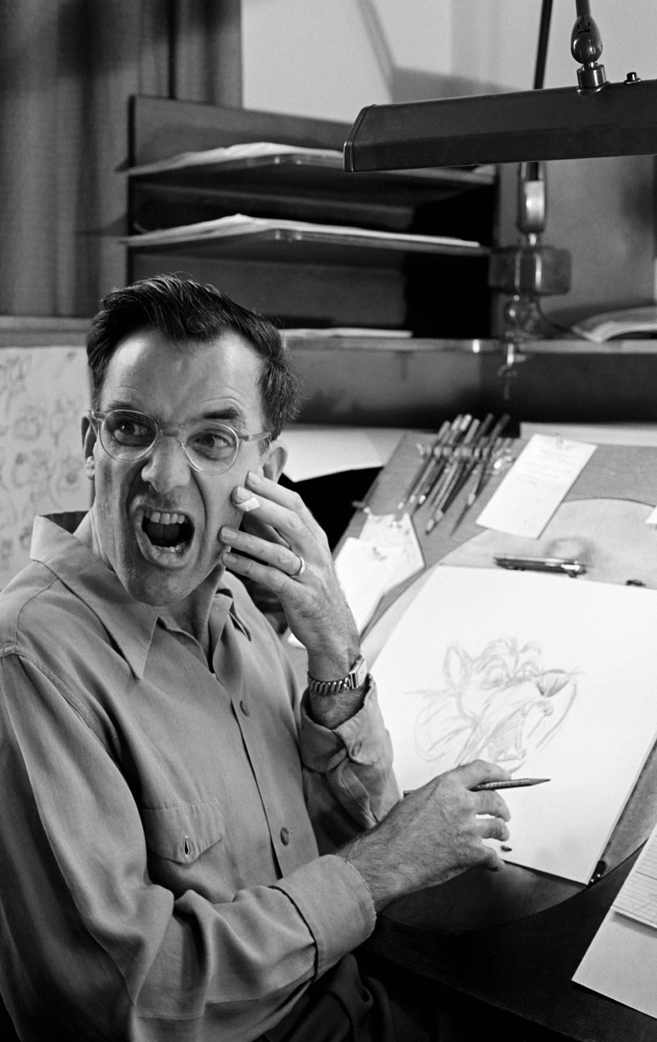 Disney animator and a character he's drawn, 1950s