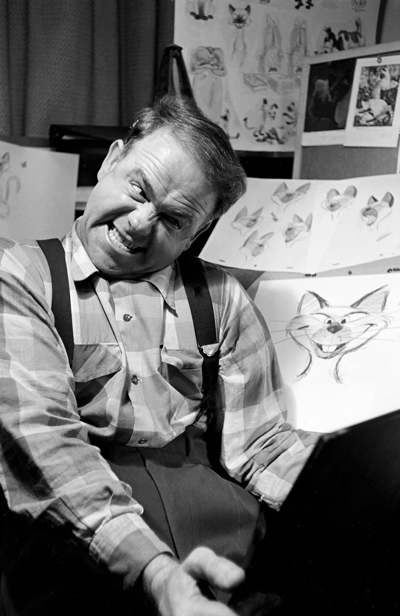Disney animator peers in a mirror to get facial expressions just right, 1950s