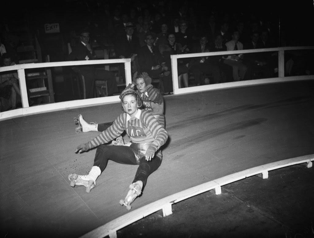 Ronnie Powell and Jeanne Goette of the New York team take a seat during the sixth annual roller derby at the Coliseum, 1940s