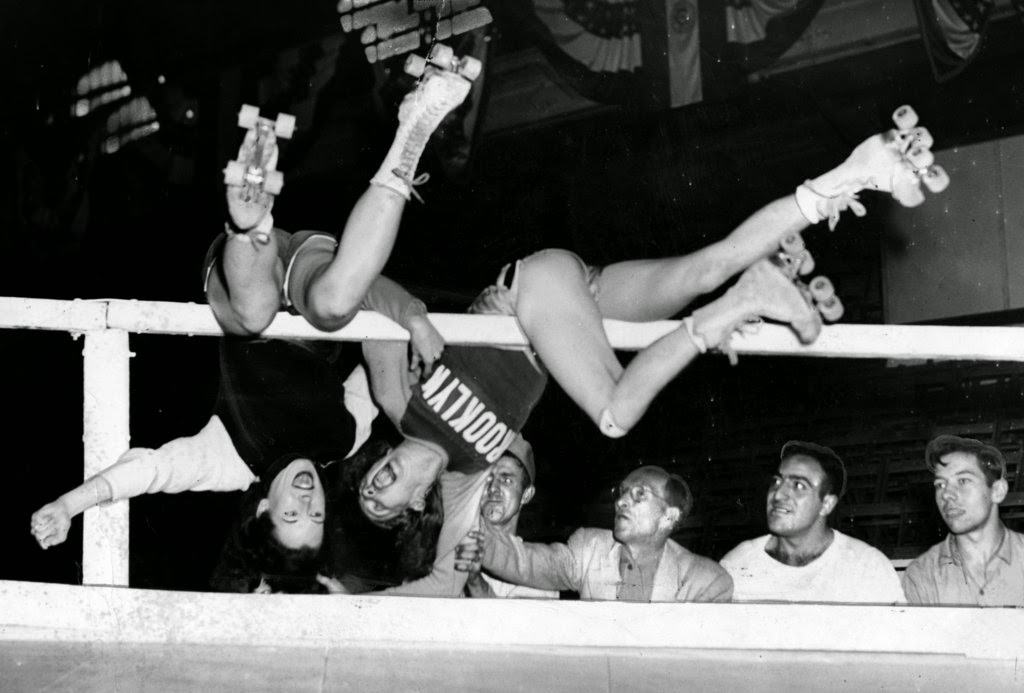 Gerry Murray of Chicago and Annabelle Kealey of Brooklyn collide with the rail on a turn during a match, 1940s