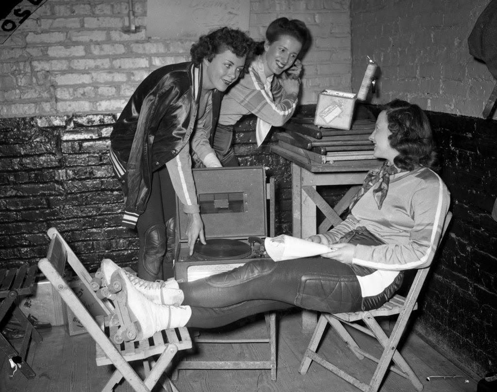 Monte Jean Payne, Chicago roller derby captain, Marilyn Bullock and Catherine Virva of McKinley High School in Chicago are in the dressing room during a roller derby at the Coliseum, 1940s