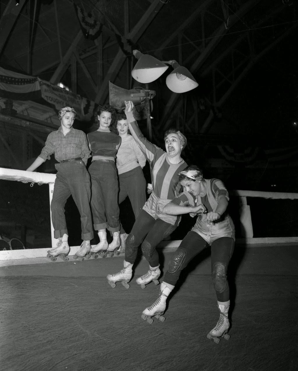 Roller derby veterans Mary Casey and Terry Anderson practiced a move while trainees Betty Backus, Barbara Begley and Irene Van Kirk watched along the rail during a tryout at the Coliseum, 1950s