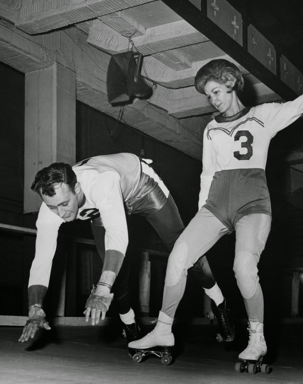 Mary Lou Palermo trips teammate Bob Venter in a skills demonstration at a training school in Chicago, 1960s